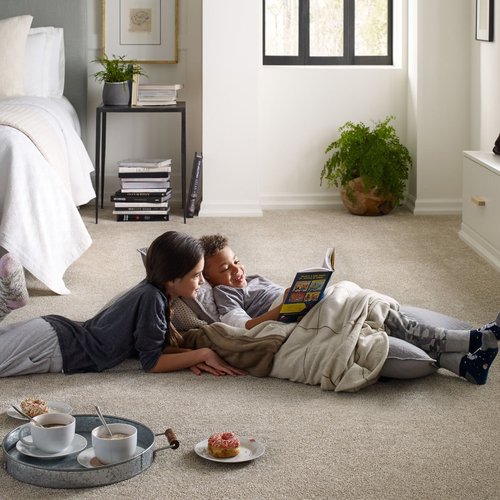 Two children reading on bedroom carpet from Poway Carpets in Poway, CA