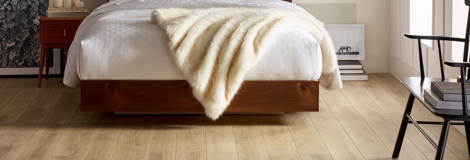 Bedroom with wood-look luxury vinyl flooring from Poway Carpets in Poway, CA