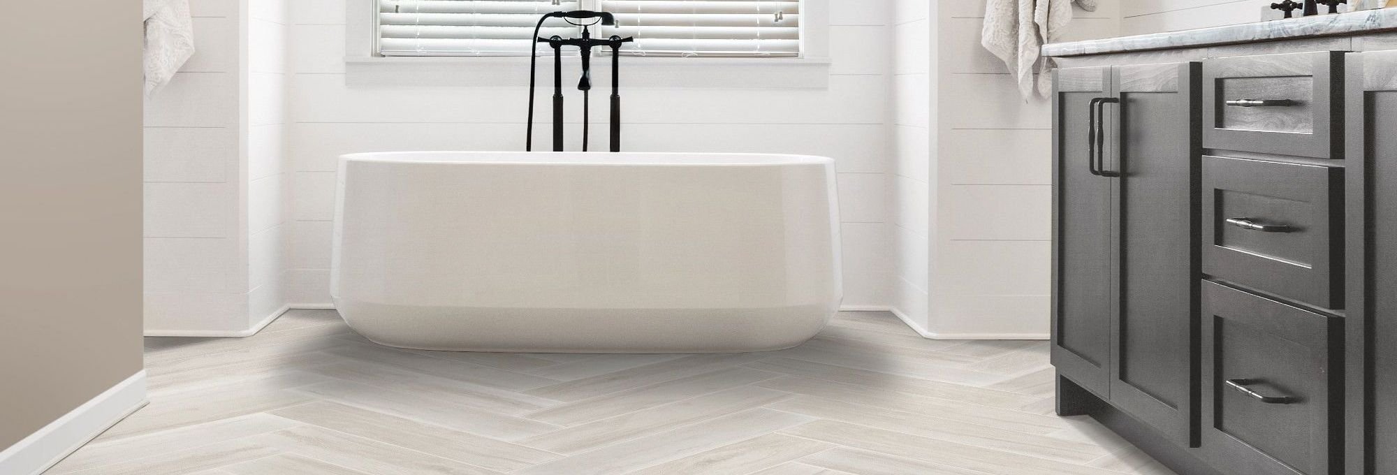 White bathtub bathroom with tiled floor from Poway Carpets in Poway, CA